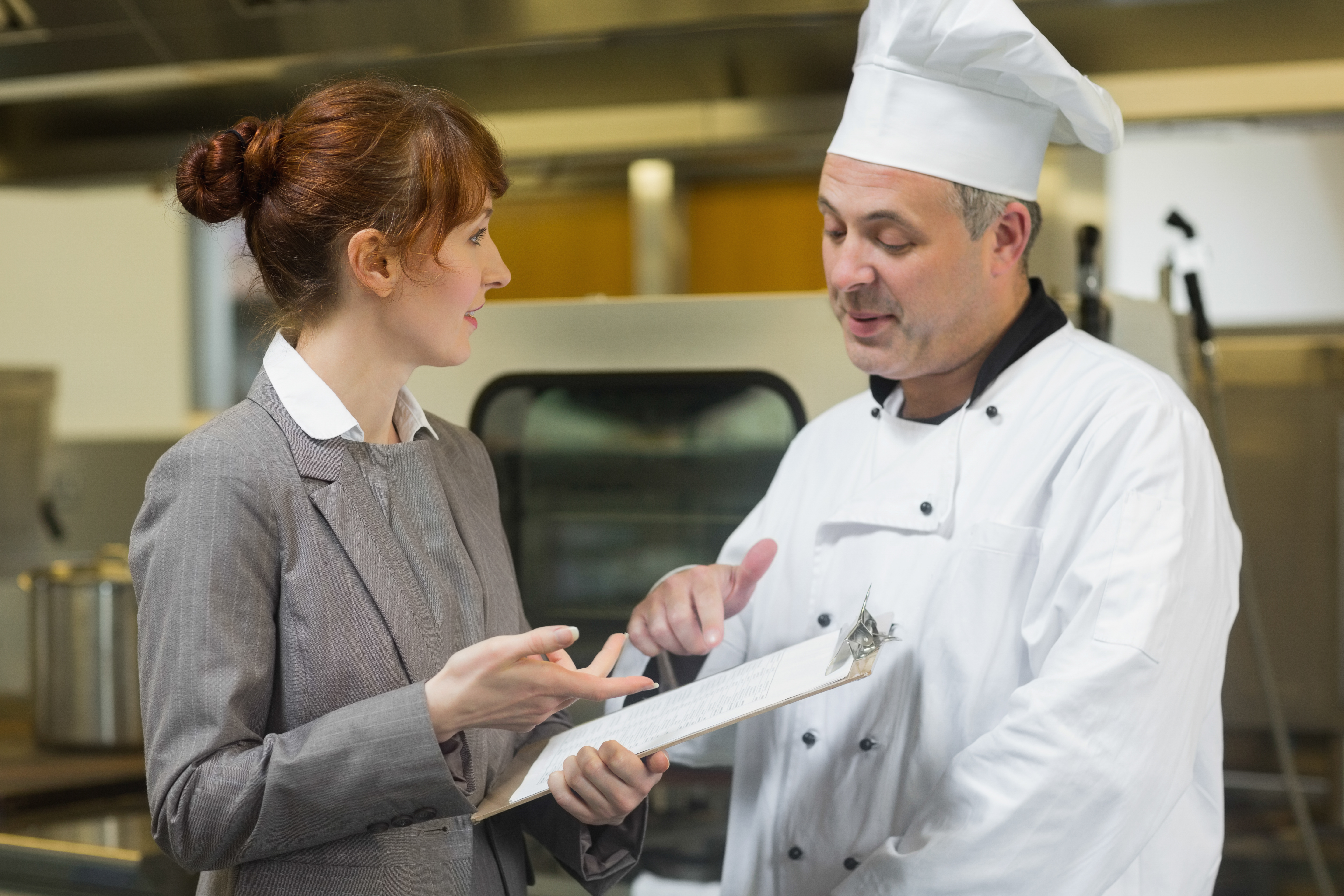 Chef and Manager discuss details in kitchen